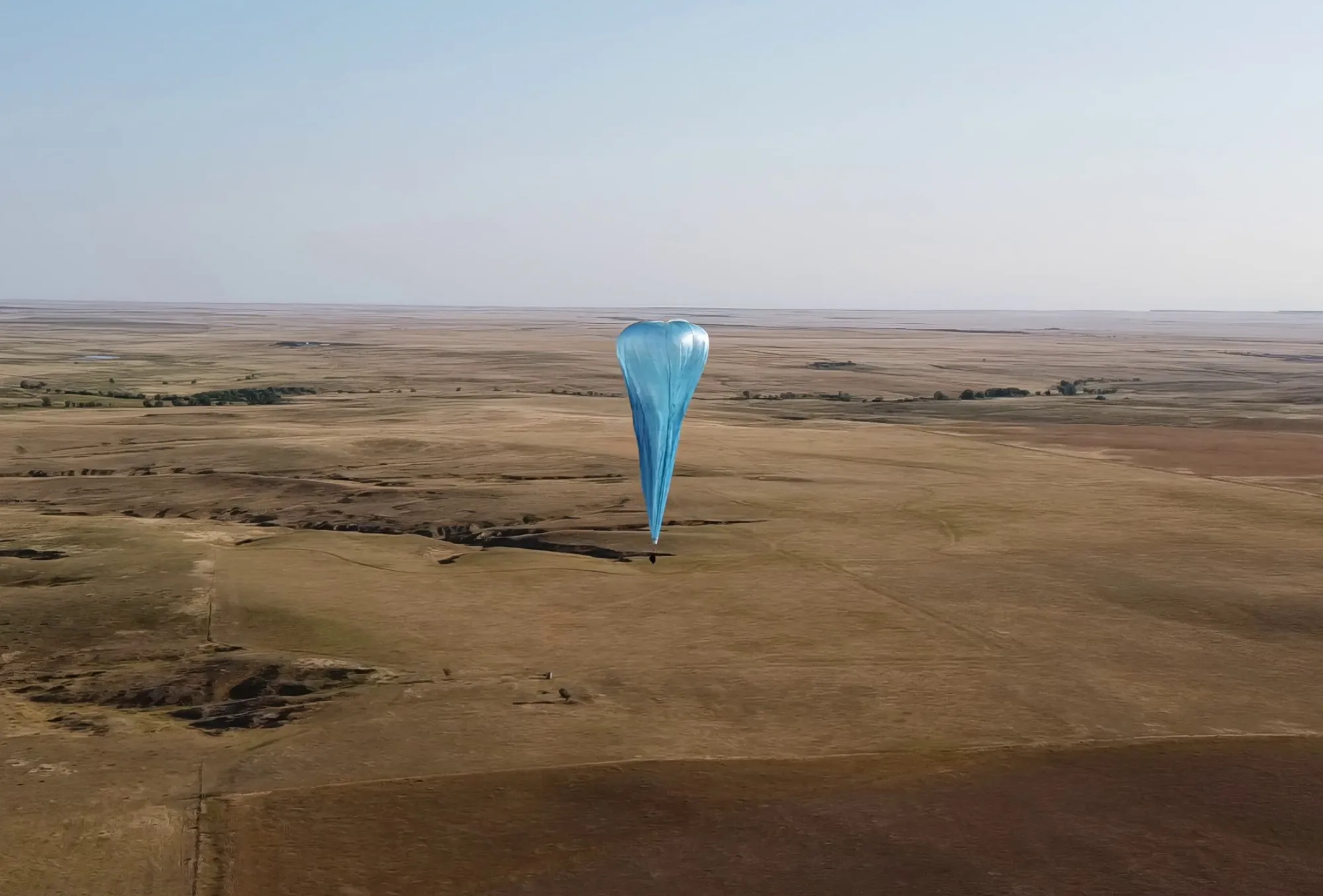 Microballoon in flight over terrain